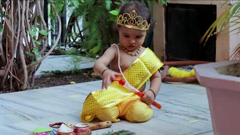 adorable infant dressed as hindu god krishna cute facial expression with flute at janmashtami