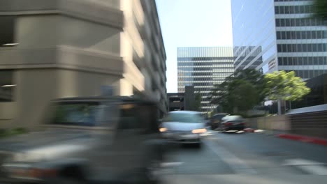 a car travels along a street in century city los angeles as seen through the side window 5