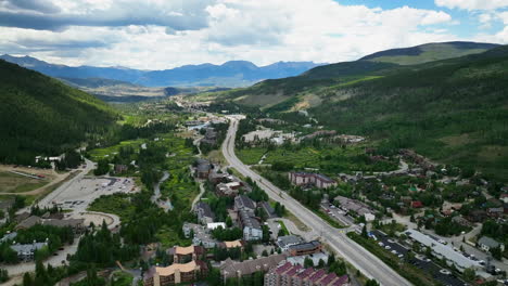 downtown new keystone ski resort city town aerial cinematic drone summer breckenridge colorado vail resort epic pass ski snowboard bike golf parking lot buildings forward slowly motion