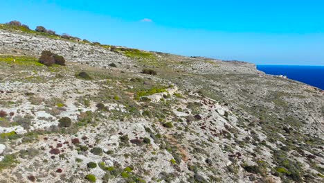 Drone-shot-over-rocks-in-nature-and-next-to-the-Mediterranean-sea-of-Malta