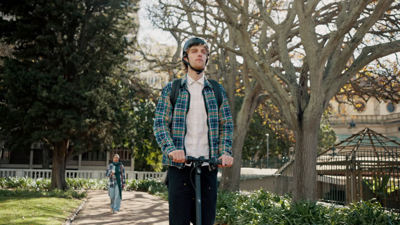 Young man riding an electric scooter in a park