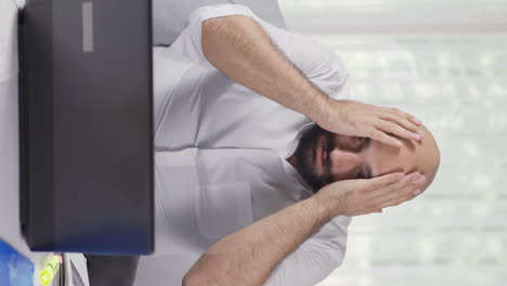 Vertical-video-of-Home-office-worker-man-having-a-nervous-breakdown.