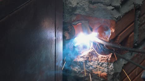 close shot of a worker welding metal on a window frame