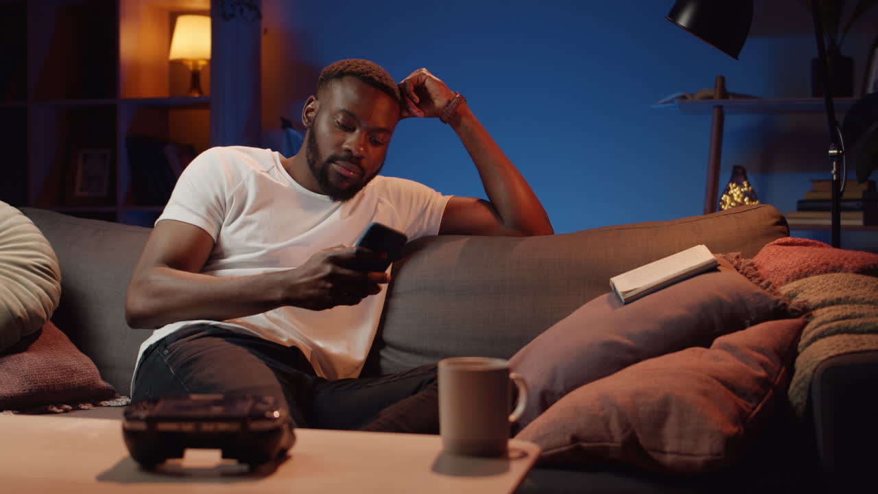 Man Relaxing on Couch with Phone
