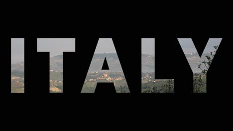 Aerial-Drone-Shot-Of-Villages-And-Mountains-In-Italy-With-Graphic-Spelling-Out-Italy