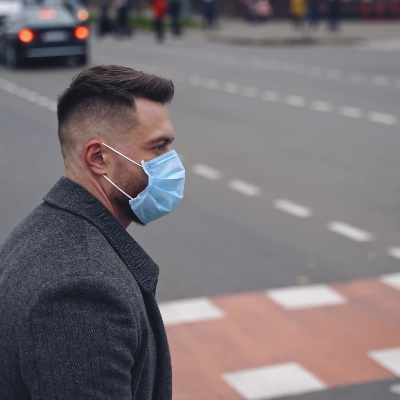 Guy wearing safety mask and walking on a road. Responsible behavior during world covid-19 pandemic