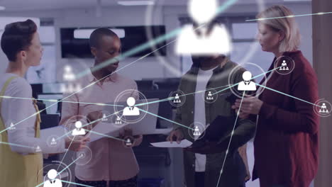 animation of network of connections over diverse colleagues using laptop at meeting in office