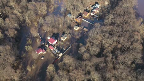 aerial photography in motion. view over houses flooded with water among the forest . seasonal wetlands - an overview.