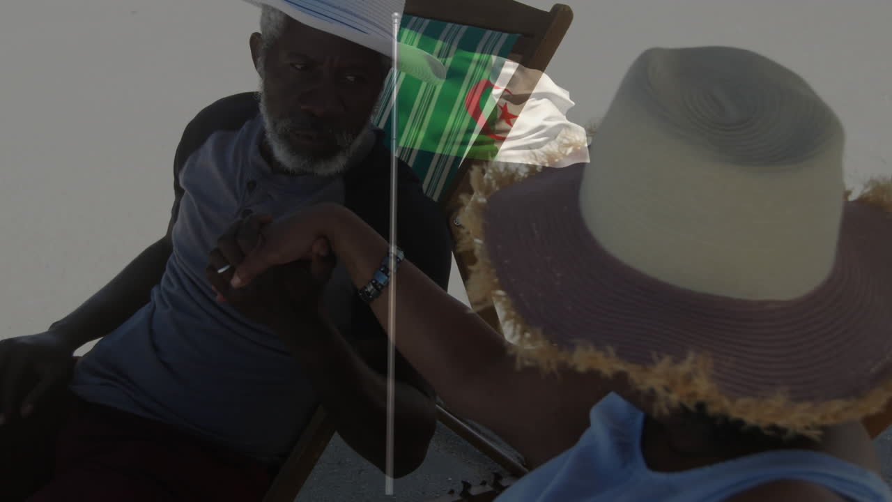 Elderly couple relaxing on beach chairs with Algerian flag overlay animation