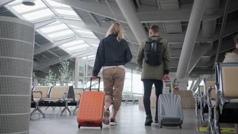 couple walking through airport terminal