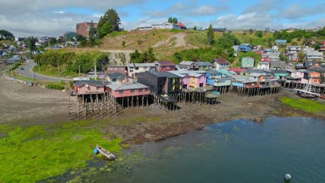 aerial view around of palafitos stilt houses on the coast of castro, chiloe