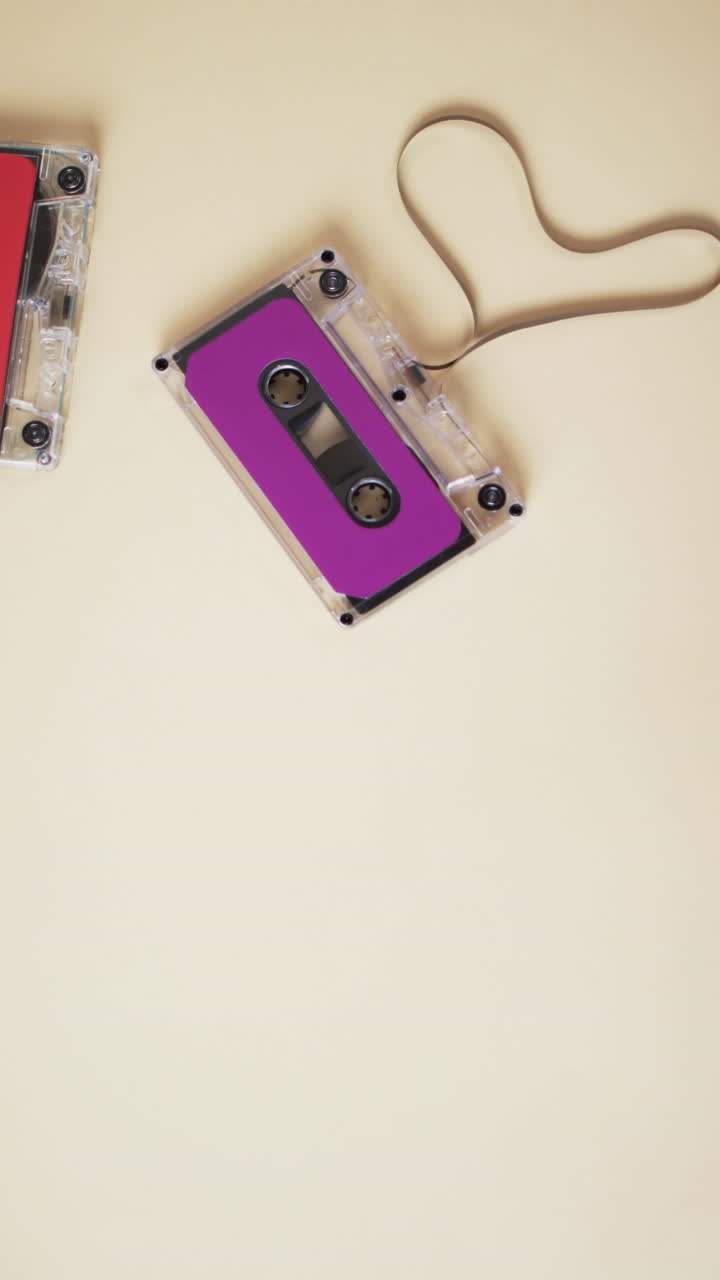 Vertical video of retro tape with pink label and copy space on yellow background
