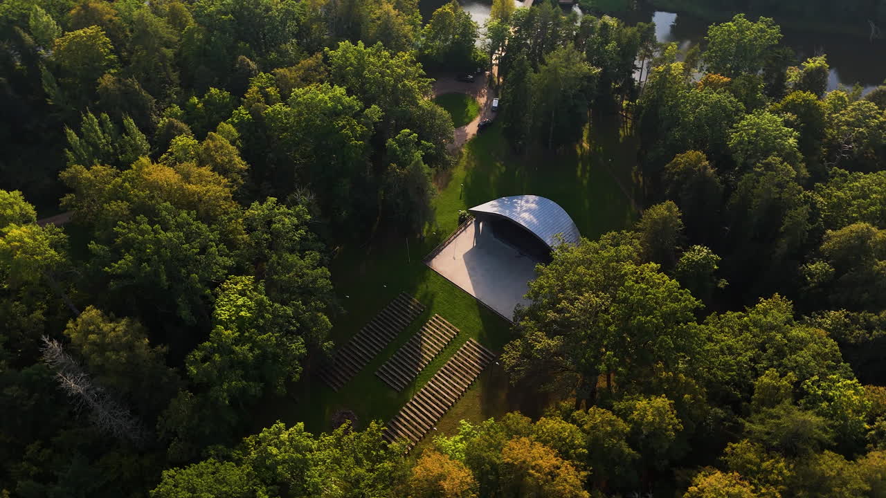 Top down aerial over forest canopy and small home near Pavilosta, Latvia