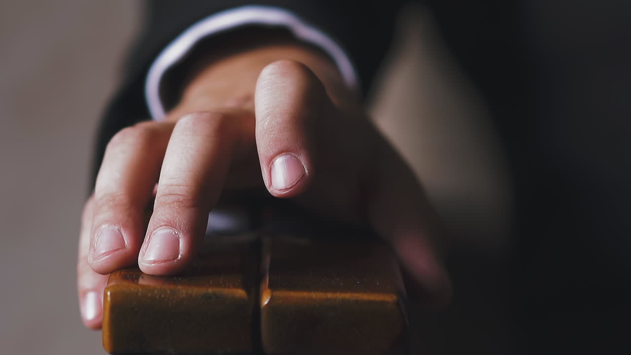 el hombre de negocios toca el reposabrazos del sillón con el dedo.