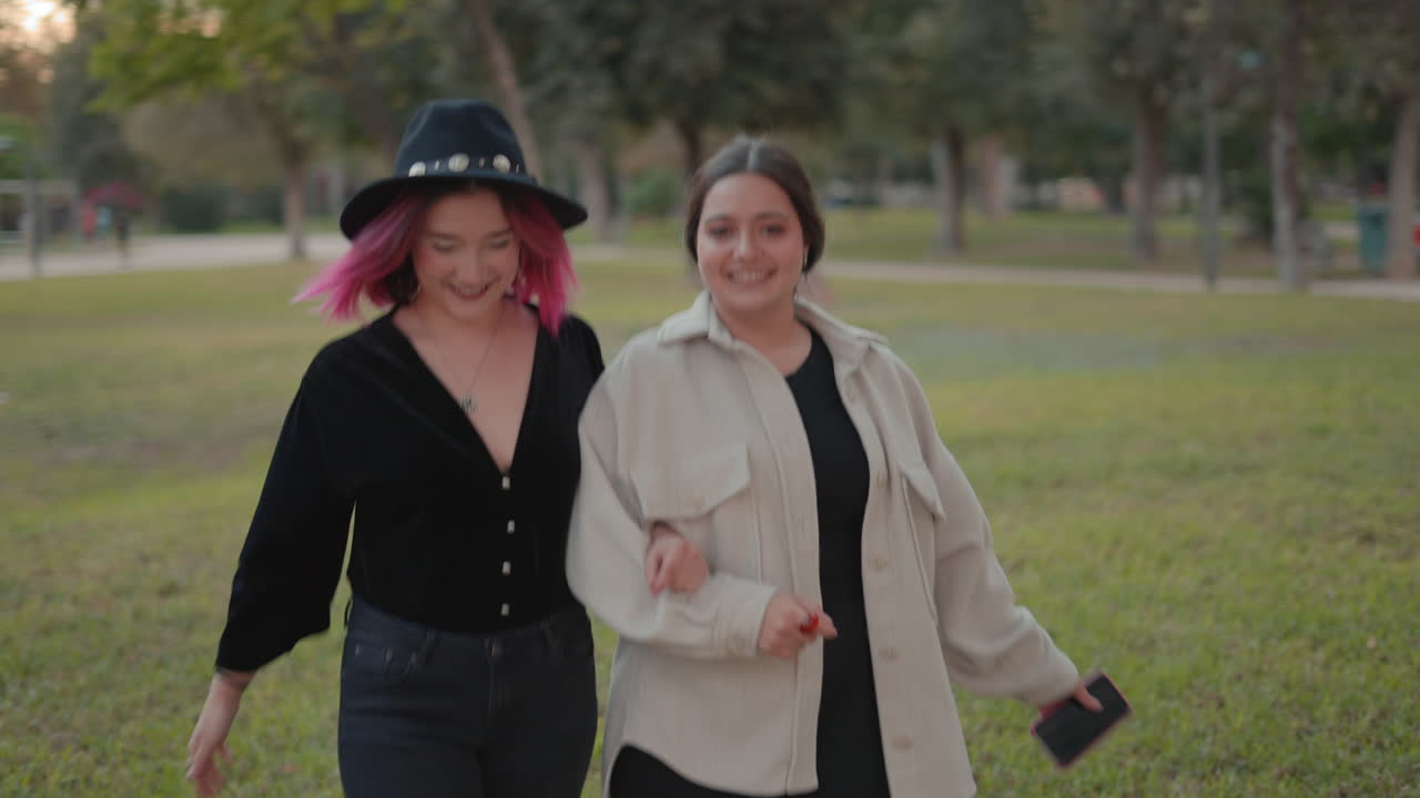 Two Women Friends Walking in a Park