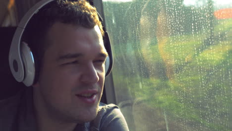 Man-dancing-and-singing-with-music-in-train