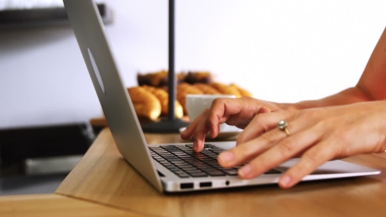 Woman working on laptop at counter