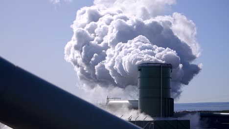 industrial geothermal pipe blowing steam into the atmosphere