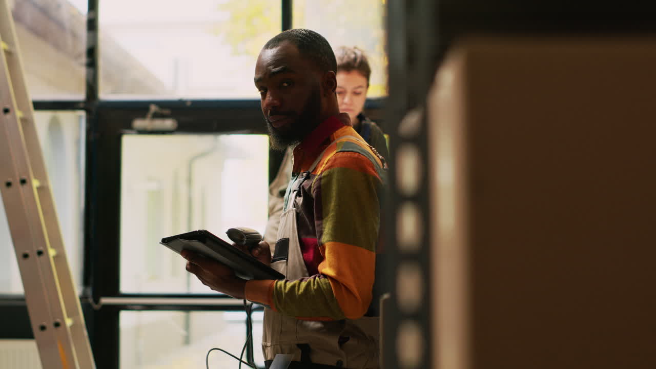 Warehouse workers with ladder and boxes