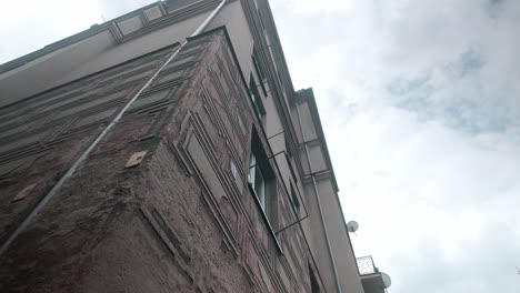 looking up to urban soviet built residential corner apartment block