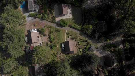 aerial view of a secluded residential area with houses and lush trees