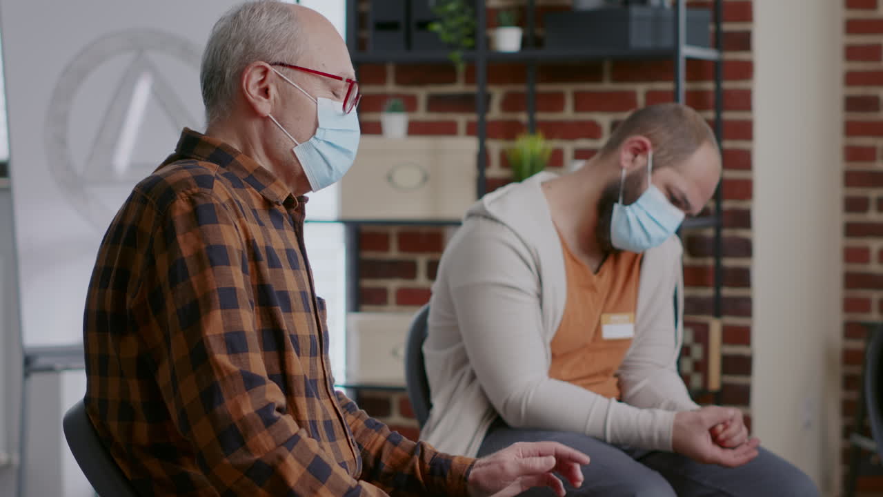 Close up of old person talking about alcohol and drug addiction at aa group therapy session