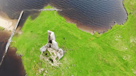 aerial shot over castle ruins in the sottish highlands