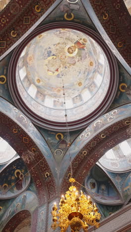 orthodox church interior with intricate dome and frescoes