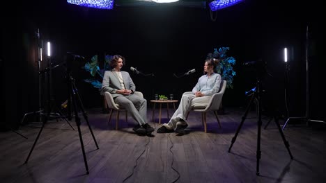 two people recording a podcast in a studio
