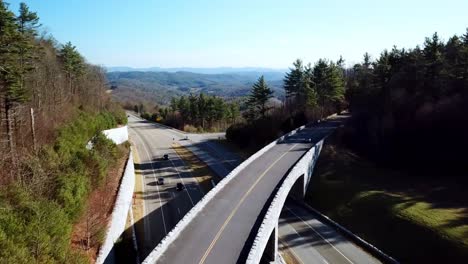 car drives over blue ridge parkway bridge near boone and blowing rock nc, north carolina