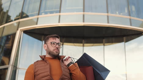 man whistling for cab after shopping