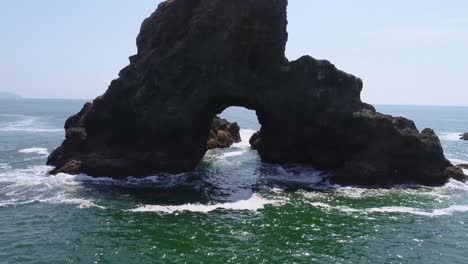 An-orbiting-drone-shot,-rotating-around-an-isolated-sea-mount,-off-the-Oregon-coast-in-the-Pacific-Northwest