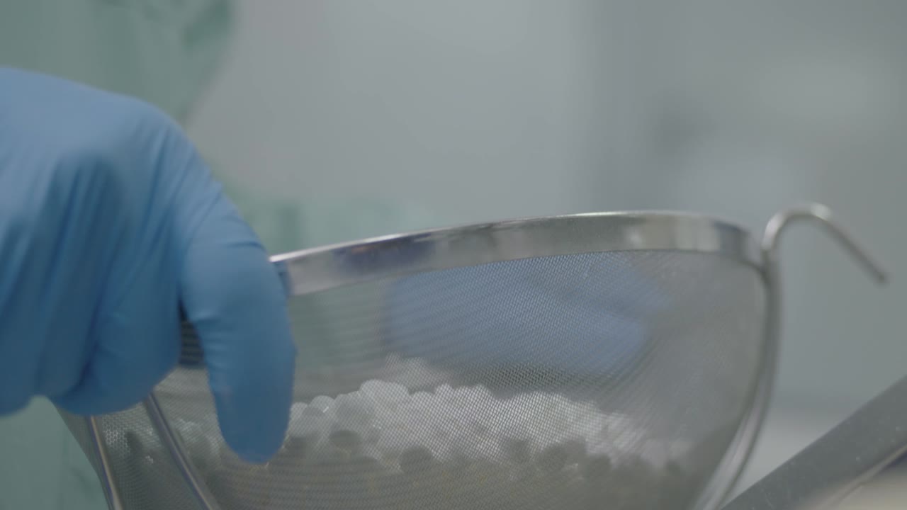 researcher selects and moves all tablets in the funnel to ensure they have the proper consistency