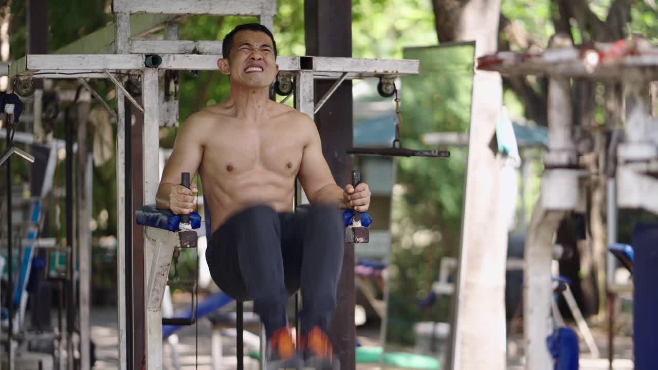 Man doing workout on outdoor gym equipment