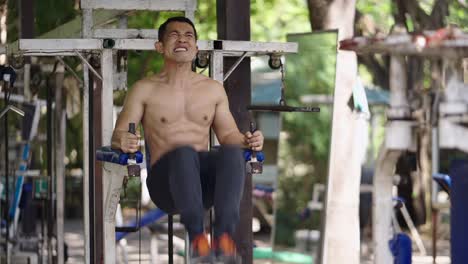 man doing workout on outdoor gym equipment