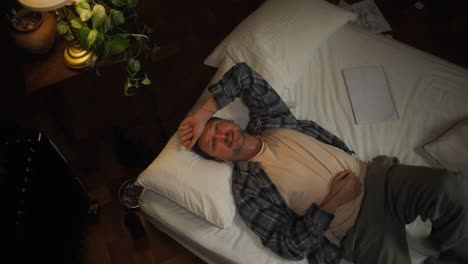 man relaxing on bed