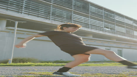 sportswoman juggling soccer ball on the street