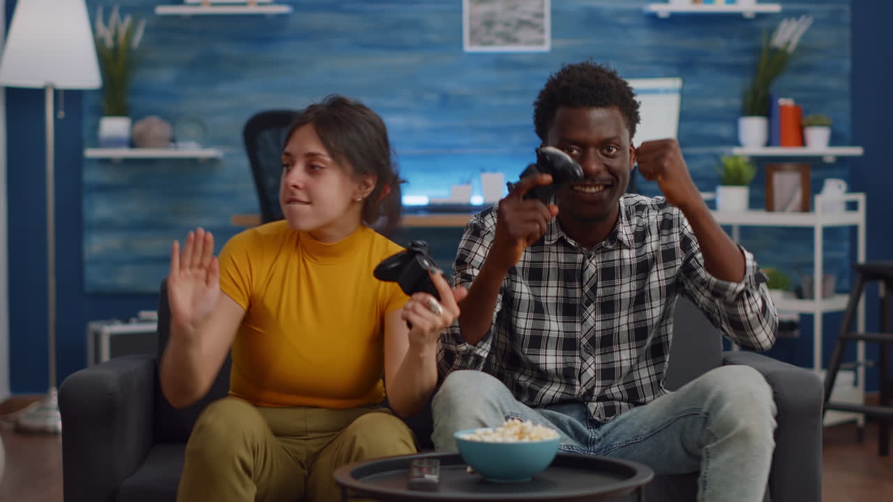 POV of interracial couple playing video game on console