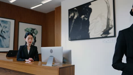 businesswoman checking smartwatch in office