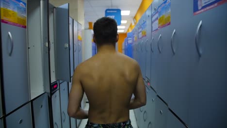 man walking through a locker room