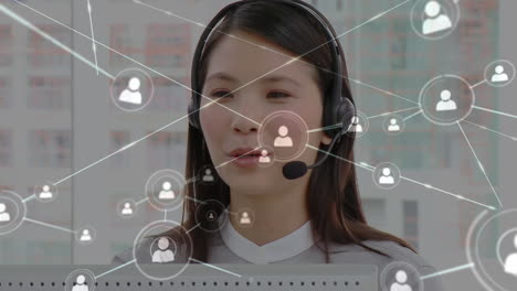 animation of networks of connections with icons over businesswoman using phone headsets