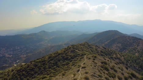 aerial cinematic drone shot over misty mountain range in the troodos mountains, cyprus