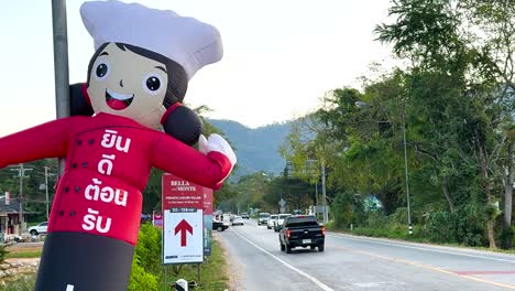 inflatable figure waving beside a busy road