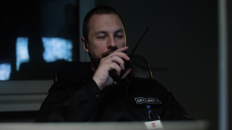 Man with walkie talkie in the hut at night