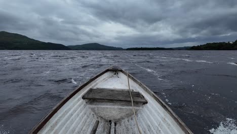 pov lake boat ride on rough water, overcast sky, serene landscape
