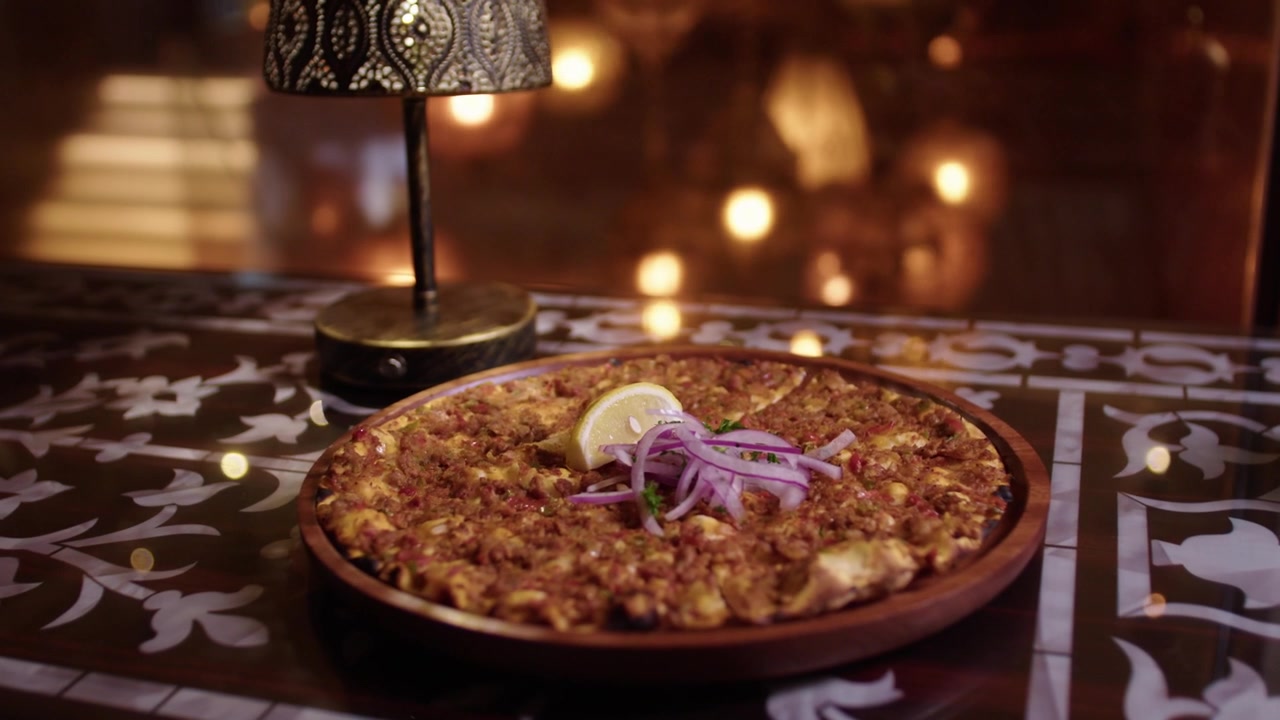 Delicious traditional Turkish lahmacun served in a cozy, ambient restaurant setting