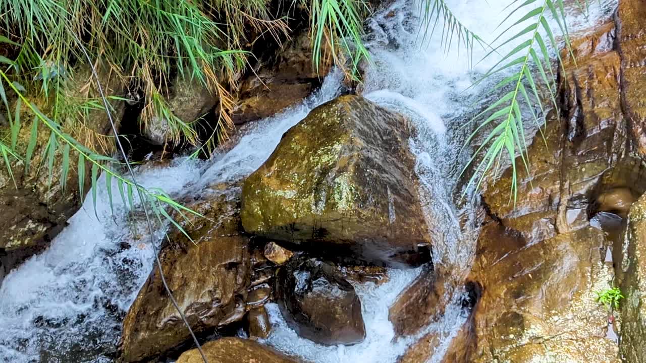 Closeup top down view of fast flowing frothy whitewater of Kadiyanlena falls waterfall and Mahaweli river near Ella in Sri Lanka