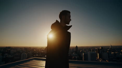 man overlooking city at sunset