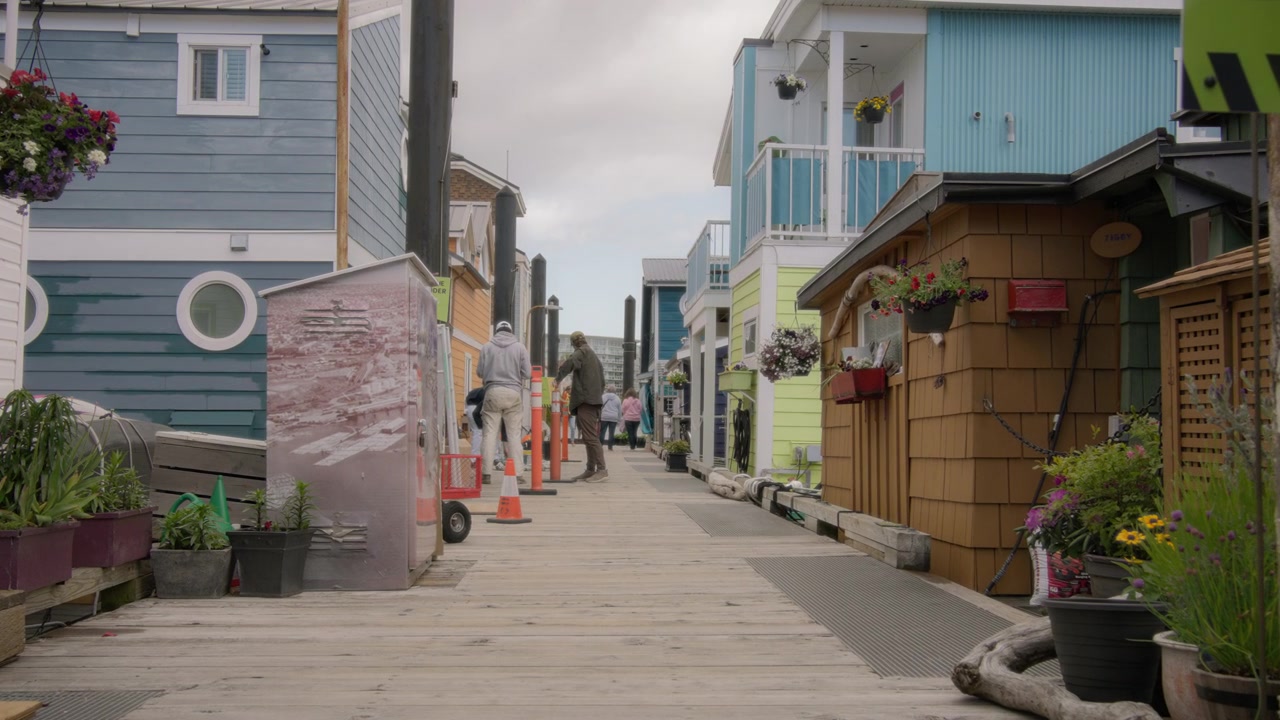 Walking through the street with floating homes in Victoria Harbour, Canada
