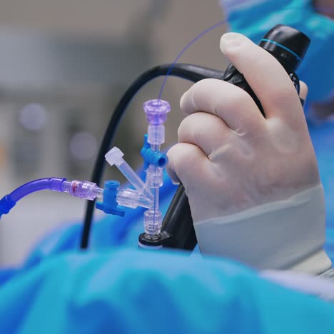 surgeon work with innovative equipment. doctor's hand holds modern equipment while perform an operation. close-up.